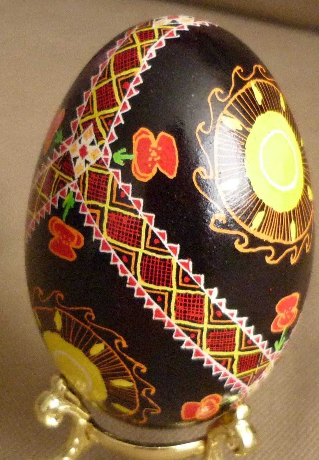 a goose-egg pysanka with poppies, suns, and neverending lines