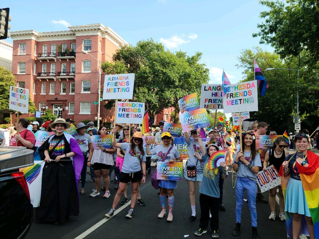 A couple dozen people in pride regalia at the Capital Pride parade. Many hold signs that say the names of their Quaker meetings in rainbow colors. Many also hold rainbow signs saying “Love thy neighbor, no exceptions” /images/2023/quakers_pride_2023.jpg
